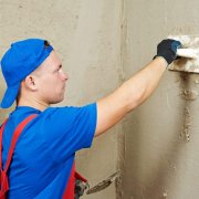 How is wall plastering with cement mortar