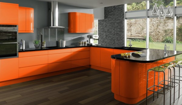 في الصورة ، مطبخ برتقالي بجدران رمادية