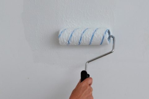 Adhesive is applied to both the wallpaper and the wall.