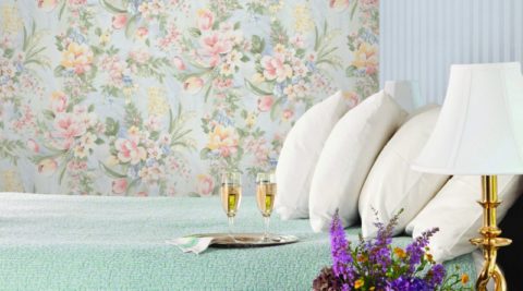 A combination of stripes and floral pattern on the wallpaper